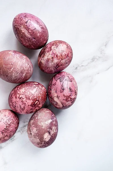 Easter. colored chicken eggs. Burgundy color. Painting with hibiscus.