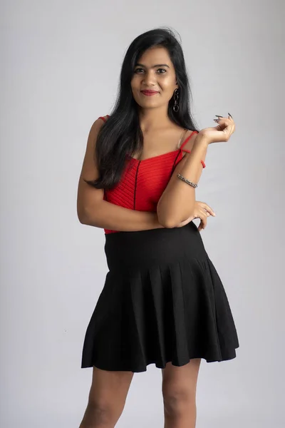 Jovem Linda Menina Sorridente Roupa Vermelha Preta Posando Fundo Cinza — Fotografia de Stock