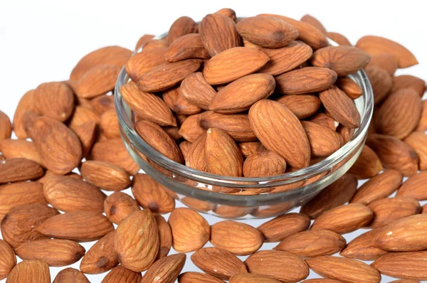 Almonds in a glass bowl with heap — Stock Photo, Image