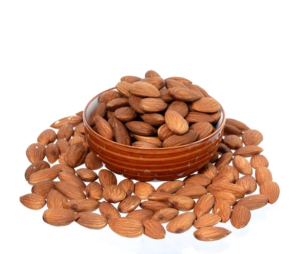 Almonds in a bowl with heap — Stock Photo, Image
