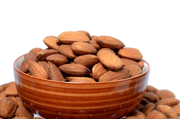 Almonds in a bowl with heap — Stock Photo, Image