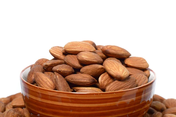 Almonds in a bowl with heap — Stock Photo, Image