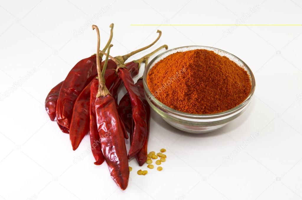 Chilly powder in bowl with red chilly, dried chillies
