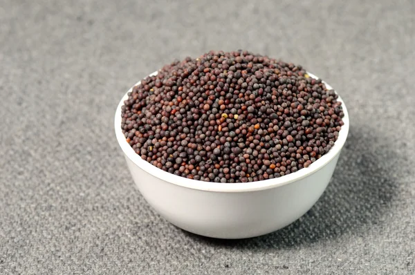 Brown Mustard Seeds in bowl on sackcloth — Stock Photo, Image