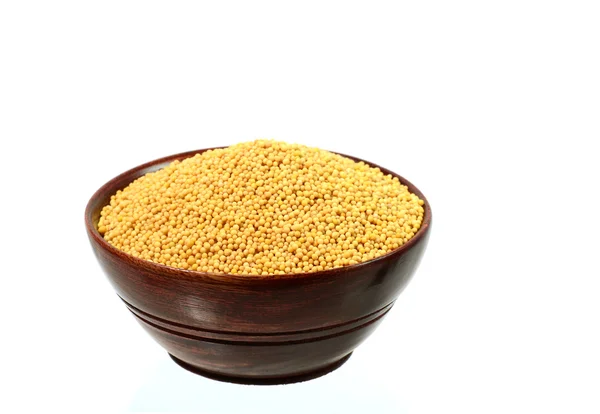Yellow mustard seeds in wooden bowl — Stock Photo, Image