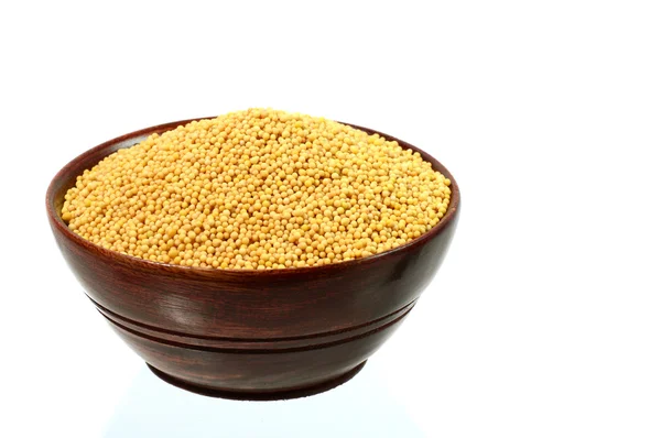 Yellow mustard seeds in wooden bowl — Stock Photo, Image