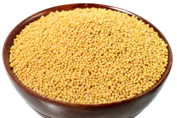 Yellow mustard seeds in wooden bowl — Stock Photo, Image