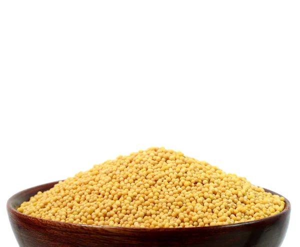 Yellow mustard seeds in wooden bowl — Stock Photo, Image