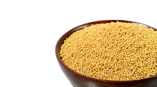 Yellow mustard seeds in wooden bowl — Stock Photo, Image