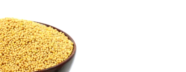 Yellow mustard seeds in wooden bowl — Stock Photo, Image