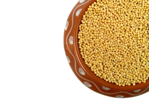 Yellow mustard seeds in clay pot — Stock Photo, Image