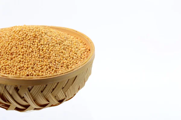 Yellow mustard seeds in wooden (Bamboo) basket — Stock Photo, Image