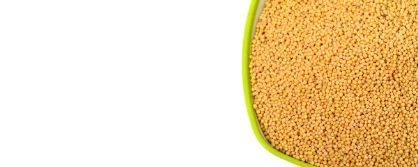 Yellow mustard seeds in green bowl — Stock Photo, Image