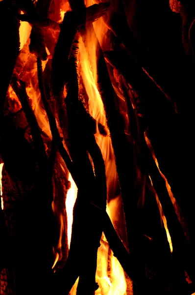 Close up of burning logs in the fireplace on black background — Stock Photo, Image