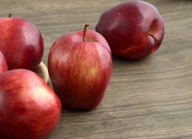 Tahta arka planda olgun kırmızı elmalar