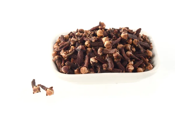 Cloves in plate isolated on white background — Stock Photo, Image