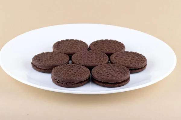 Bolachas de chocolate. biscoitos sanduíche de chocolate marrom com creme de enchimento em placa — Fotografia de Stock