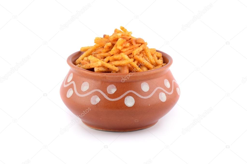 Indian Snacks. Traditional Indian deep fried falahari chivda- chivda or mixture in clay pot on white background