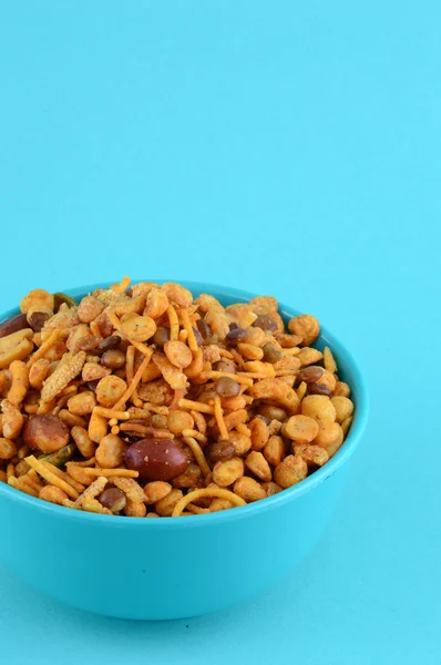 Indian Snacks : Mixture (roasted nuts with salt pepper masala, pulses, channa masala dal green peas) in blue bowl