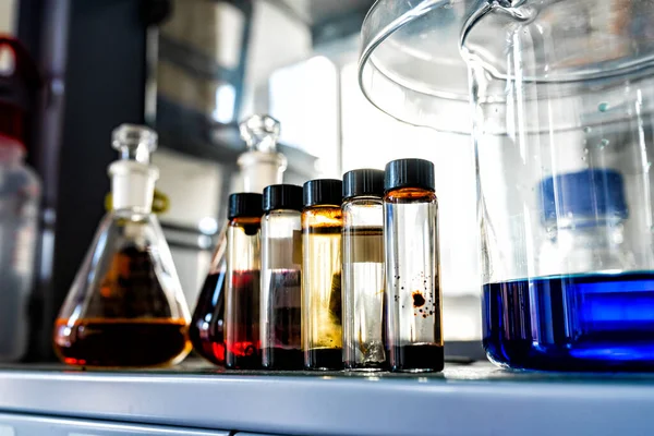 Sluitingen Van Laboratoriumglaswerk Gevuld Met Oranje Bruine Olieachtige Vloeistoffen Wetenschappelijke — Stockfoto