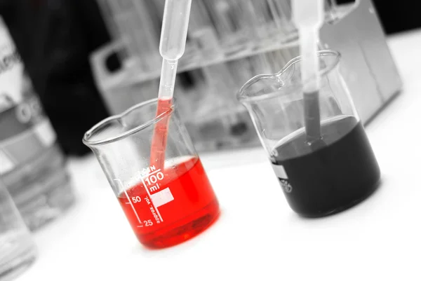 Chemistry beaker with chemicals — Stock Photo, Image