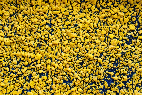 Mengsel van kleine gele en blauwe stenen achtergrond — Stockfoto