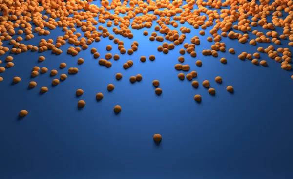 Kleine orangefarbene Kugeln gleiten entlang der blauen Oberfläche — Stockfoto