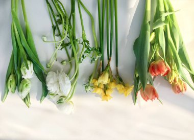 Fresh spring flowers. White tulips and ranunculus, yellow narcissus. Beauty flowers.