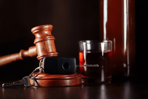 Car key, judge gavel and bottle of alcohol with glass. Drinking alcohol on driving ability — Stock Photo, Image