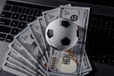 Bets, sports betting, bookmaker. Soccer ball on a laptops keyboard close-up