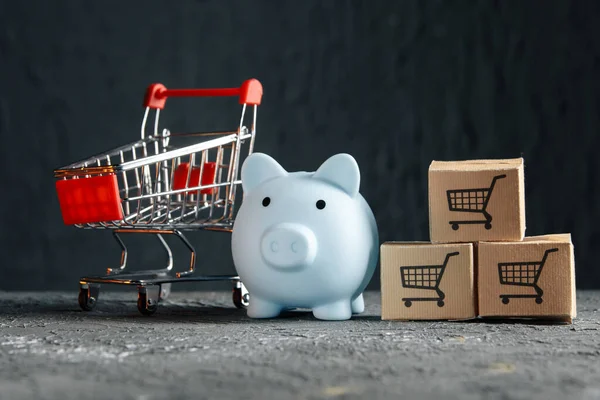 Concepto de compras online. Hucha azul con carrito de supermercado y cajas de entrega — Foto de Stock