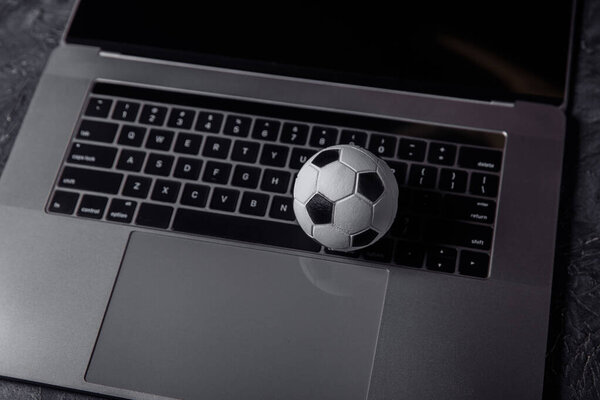 Soccer ball on a keyboard. Sport, gambling, money win concept