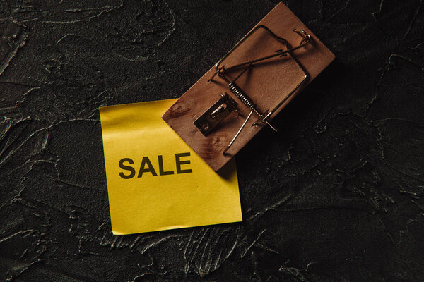 Scam or sale fraud concept. Mousetrap with inscription