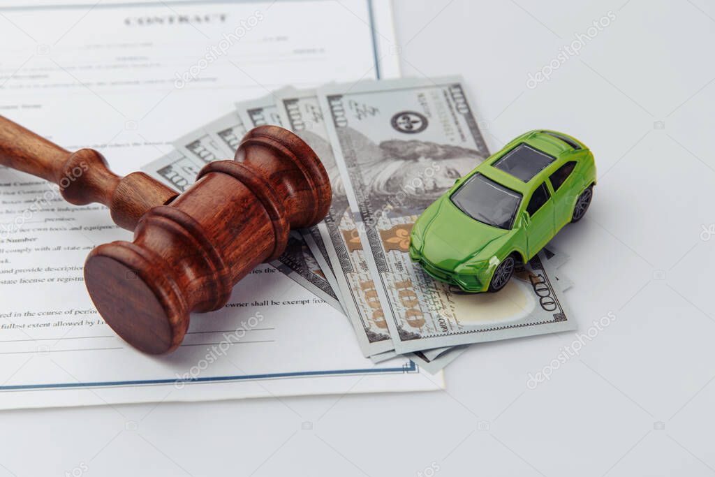 Wooden hammer, toy car, money and contract, auction concept