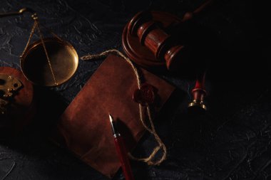 Noter aletleri. Adalet, zarf ve ahşap hakimler yakın plan çekimde.