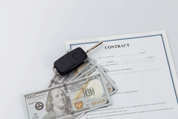 Car key, money and contract on a table. Car purchase or insurance concept