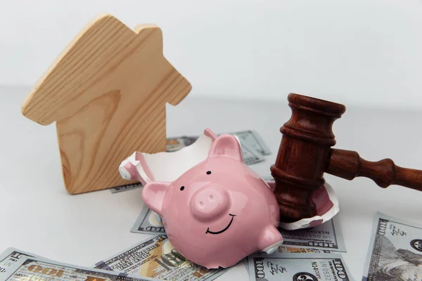 Broken piggy bank, house and judge gavel. Bankruptcy and investment concept