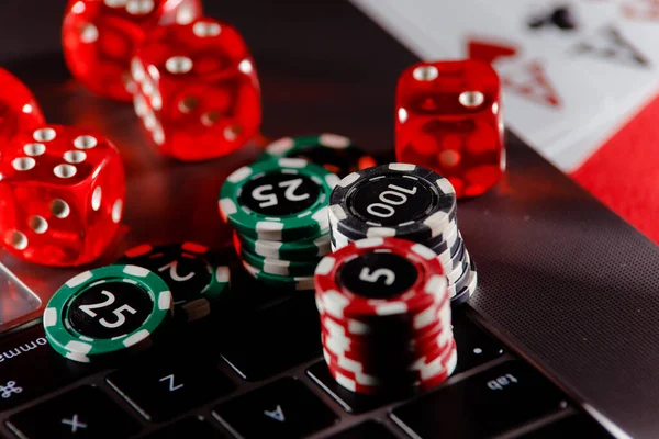 Cassino, jogo online, tecnologia e conceito de pessoas - close-up do  jogador de pôquer com cartas de baralho, computador tablet pc e fichas na  mesa de cassino verde