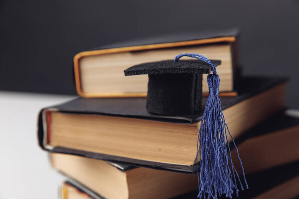 Mini graduation hat on stack of books