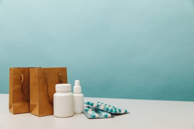 Bags with medical white containers and pills, online shopping theme clipart