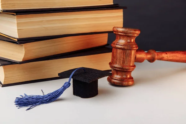 Stack of books, academic cap and wooden gavel — Stock Photo, Image