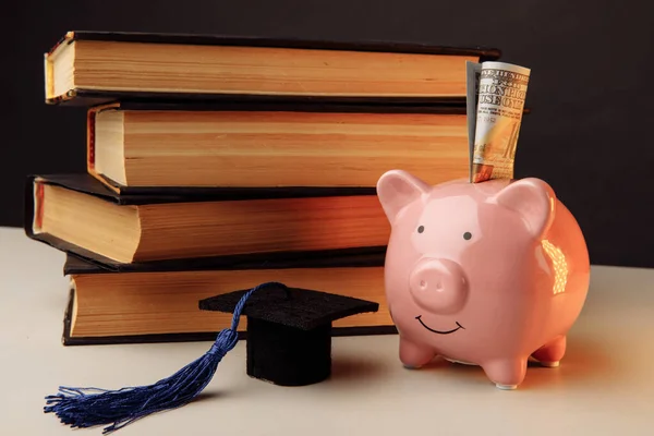 Keramische geldkist met stapel boeken. College, diploma, onderwijsconcept — Stockfoto