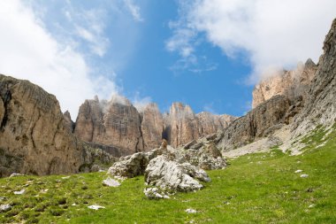 Sass Pordoi, Sella Dağı 'nda, güneşli güzel bir günde, çimenli bir yerde. Arka planda Dolomite Dağı