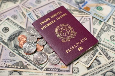 Italian Passport on top of US Dollar Banknotes and Coins. Travel to the United States of America. Italy Identification Passport. Travel Expenses