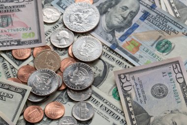 Half Dollar coin on Dollar Banknotes and differed USD coins. American Currency. Federal Reserve