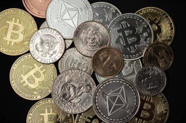 One dollar coin on half dollar and gold Bitcoin coins. Digital crypto currency Bitcoin, Ethereum and Litecoin with USD