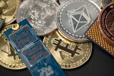 Ethereum coin next to microprocessor and circuit board. Bitcoin and ETH coins with one dollar coin. Digital crypto mining concept.