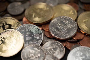Bitcoin and Dollar coins one cent coins on US dollar bills. Electronic money exchange concept