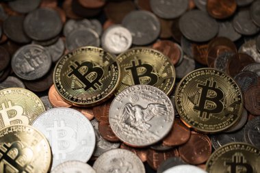 A pile of coins, US Dollar coins next to Crypto coins. Gold and Silver Bitcoins. Digital Currency concept. Trading USD with BTC