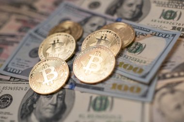 Amerika Birleşik Devletleri 'nden gelen 100 dolarlık banknotların üzerinde Bitcoin para var. Dijital kripto para birimi ve Amerikan doları. Yığınla paranın üzerinde altın parlıyor.
